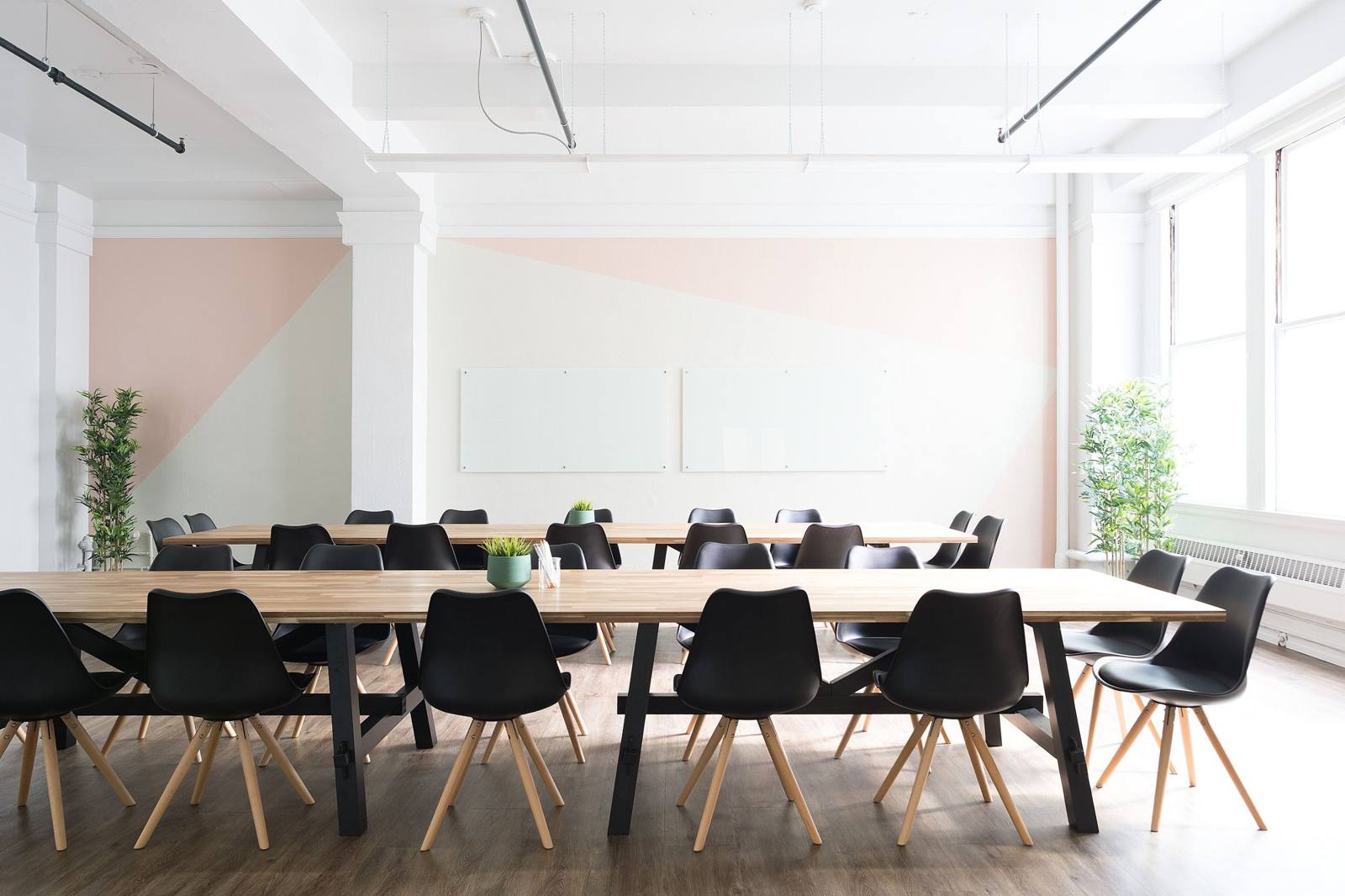 A long wooden meeting table in a bright room